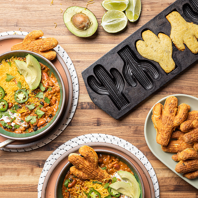 Shot of cornbread in cactus pan beside fresh jalapeno chili, and baked cactus0shaped cornbread.