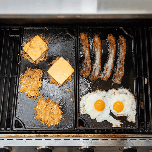 Freshly made bacon, eggs, and hashbrowns using 2 griddles on a grill.