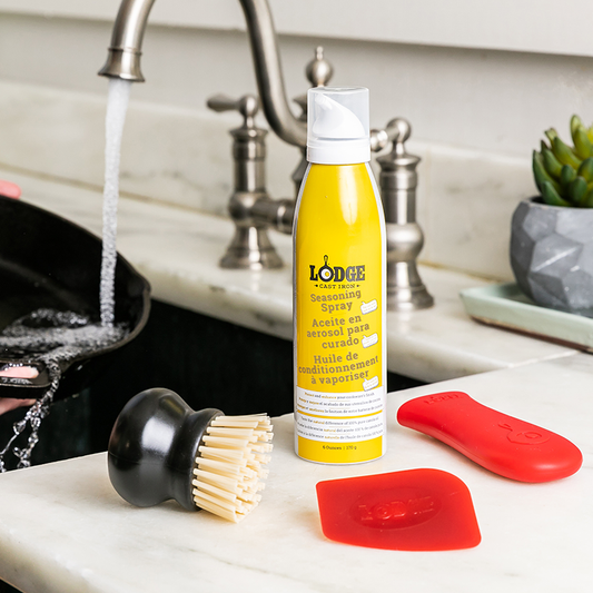 Care kit ready to use while someone starts to wash skillet in kitchen sink.