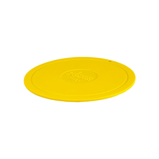 Yellow circular trivet with Lodge branding in center.