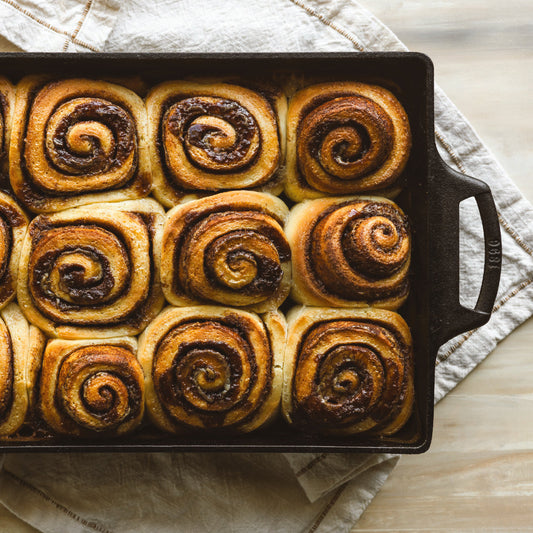 Baked cinnamon rolls in cast iron casserole dish.