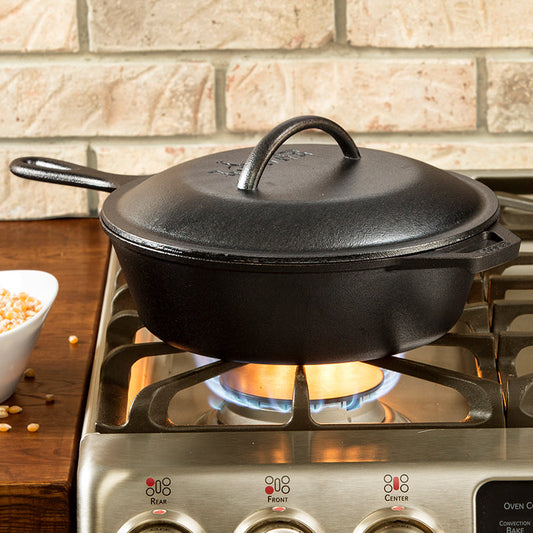 Deep skillet being used on stove with lid.