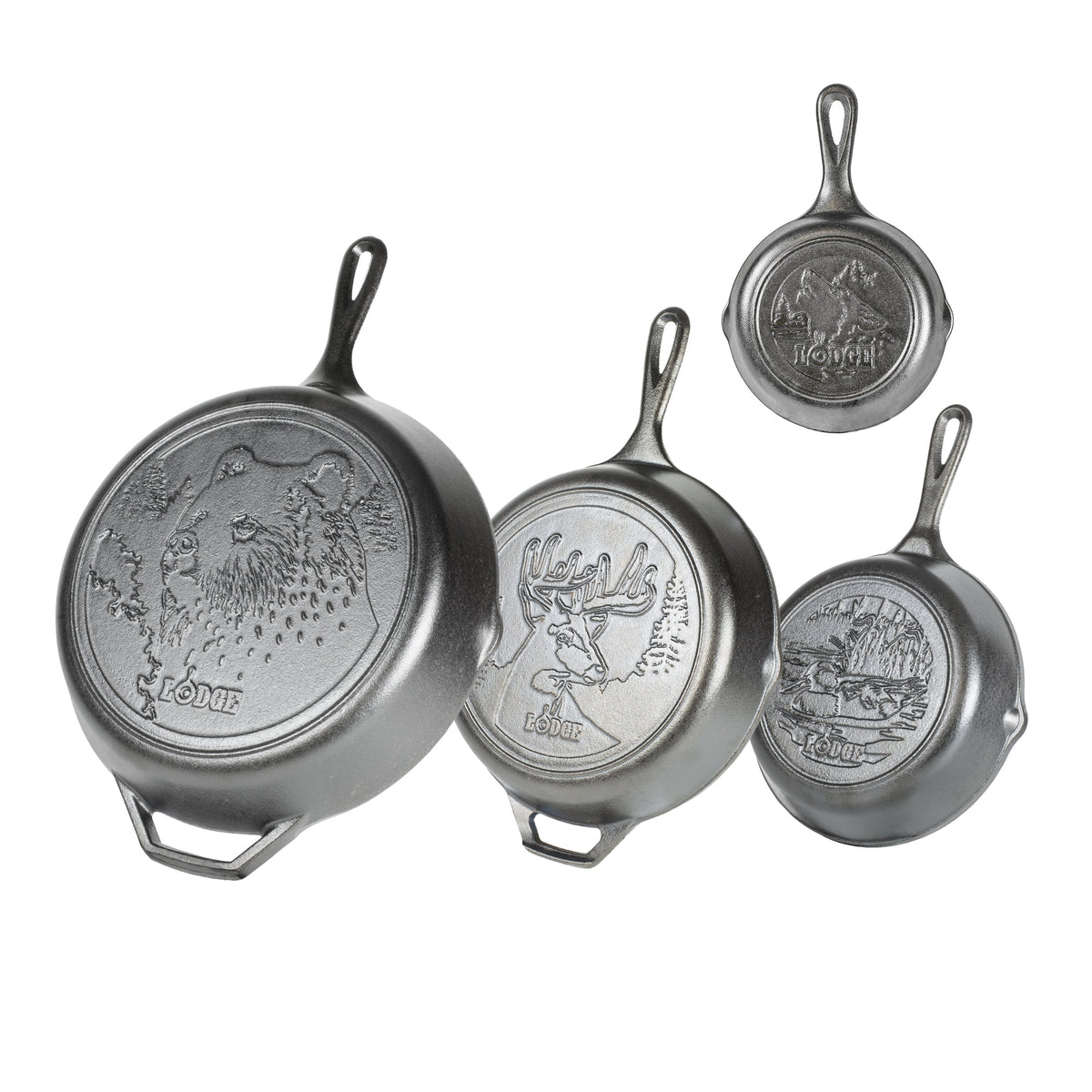 Set of four Lodge cast iron skillets with engraved designs of wildlife on the back of each skillet.