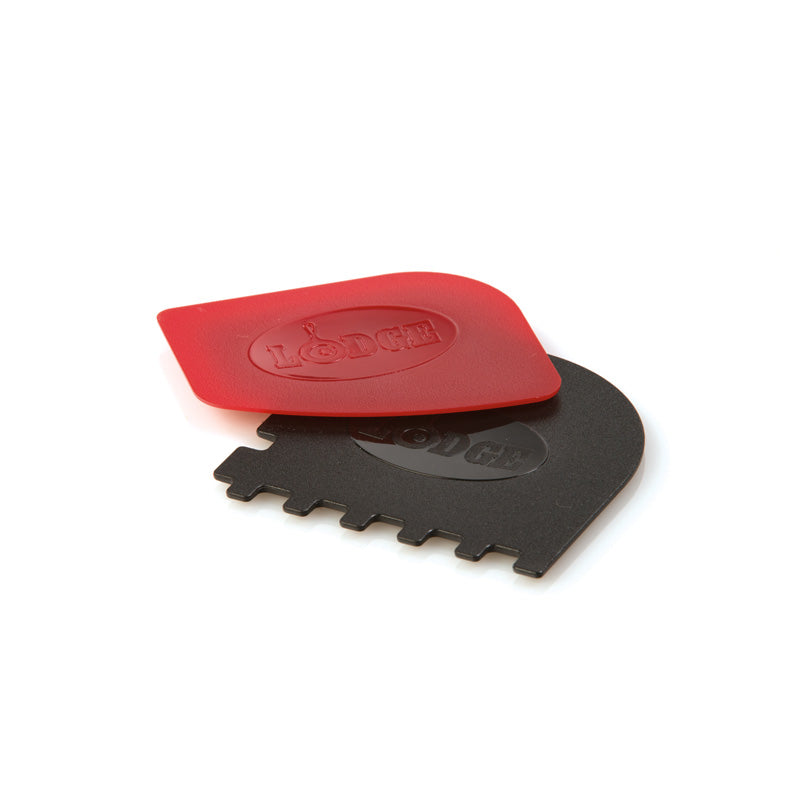 Two black and red scrapers for cleaning cast iron cookware, one with a smooth surface, which is red, and the other with a serrated edge, which is black.