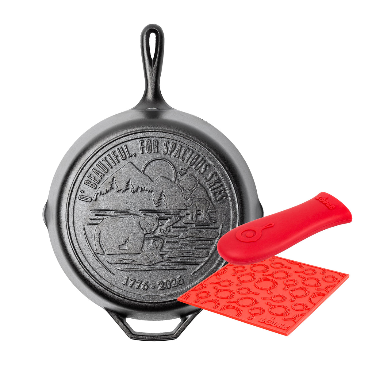 Our spacious skies skillet, featuring lyrics and imagery from America The Beautiful, paired with a red silicone handle holder and trivet.
