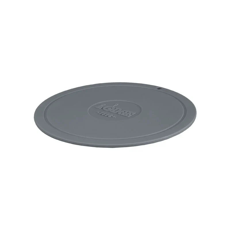 Grey circular trivet with Lodge branding in center.