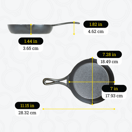 Dimensional drawing of 7 inch skillet. Depth of cooking surface is 1.44 inches, height of handle from bottom is 1.82 inches, total width is 7.28 inches, total length including handle is 11.15 inches, length of cooking surface is 7 inches, and width of cooking surface from pour spout to pour spout is 7.28 inches.