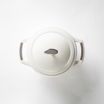 Top of white dutch oven lid with silver lid knob and silver accents on handles.