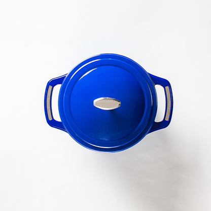 Top view of blue dutch oven featuring silver knob on lid and silver accents on handles.