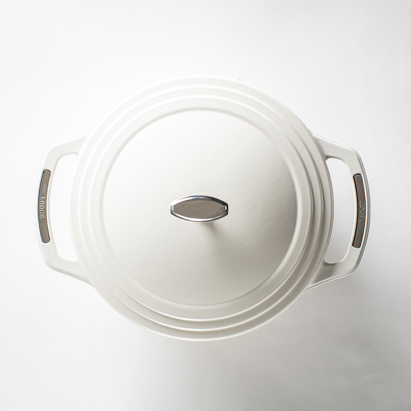 Top of white dutch oven lid with silver lid knob and silver accents on handles.