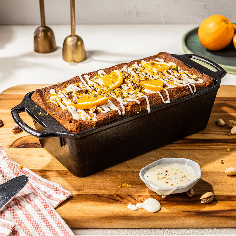 Freshly baked orange pistachio loaf drizzles with frosting.