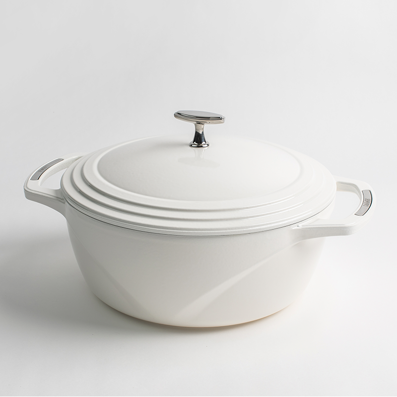 White enameled cast iron Dutch oven with a lid on a white background