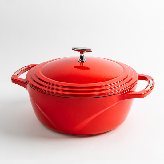 Red enameled cast iron Dutch oven with a lid on a white background