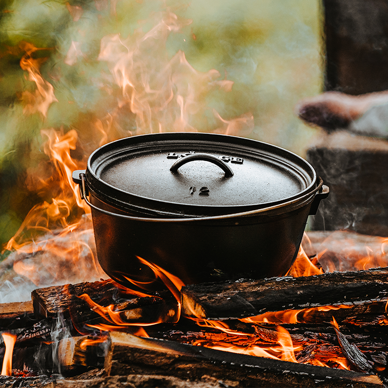Dutch oven cooking on fire.
