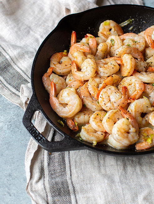 Cooked shrimp in skillet.