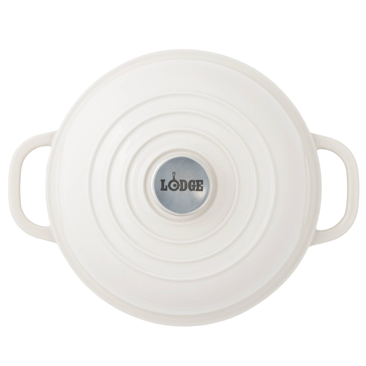 Top-down view of a white Lodge bread oven with side handles and a circular silver logo plate in the center, set against a plain white background.