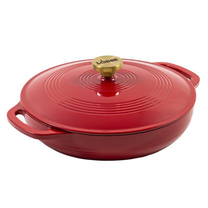A red enameled cast iron braiser with a matching lid and a gold-tone knob, shown on a solid white background.