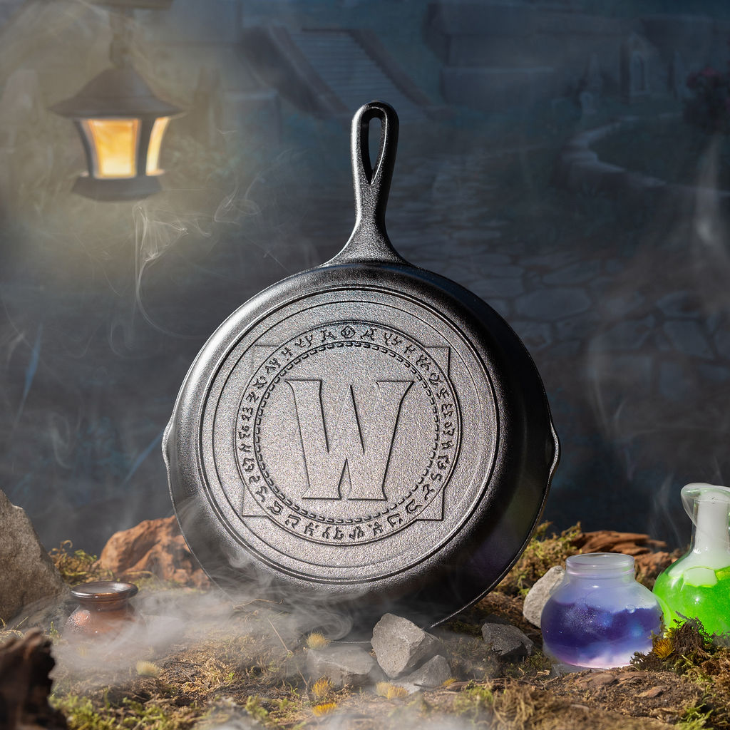 Skillet in a mystical setting with lantern and potions.
