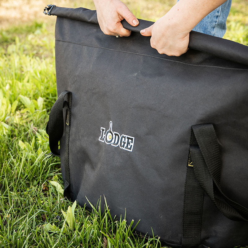Someone closing the carry-all bag outside.