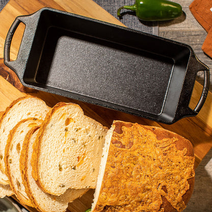 Loaf pan next to sliced bread loaf.