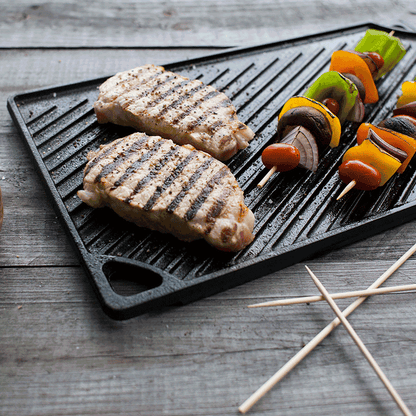 Grilled meat and vegetable skewers on a cast iron grill pan.