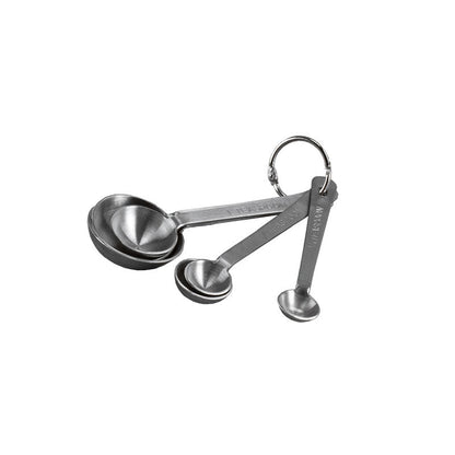 Set of stainless steel measuring spoons on a white background