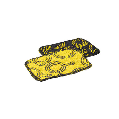 2 Yellow and black patterned scrub clothes with a skillet design spread throughout.