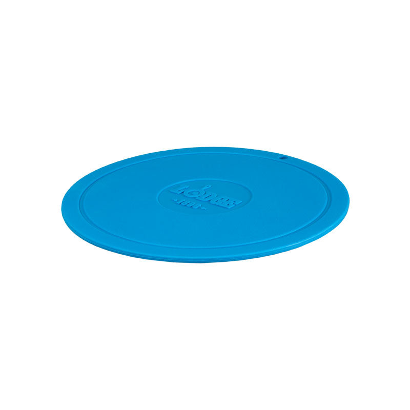 Blue circular trivet with Lodge branding in center.