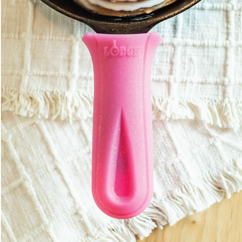 Pink handle holder with specks of glitter on skillet.