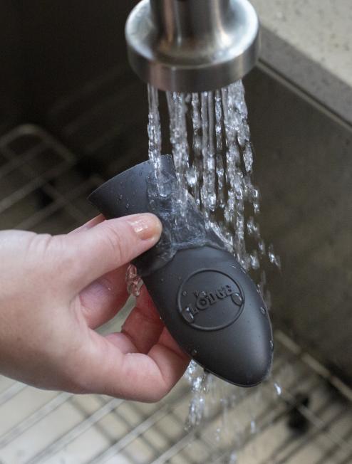 Handle holder being rinsed under sink.