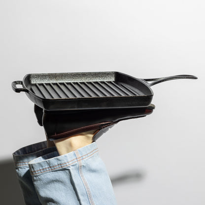 Someone propping up grill pan with feet.