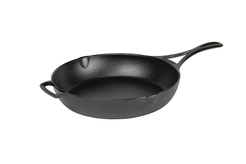 A black, cast iron skillet with a long handle and a loop handle on other side, along with two pour spouts on opposite sides.