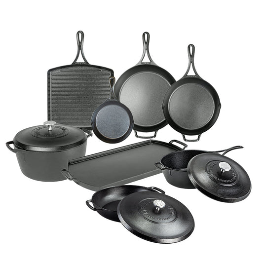 Set of black cast iron cookware including skillets, pans, and a dutch oven on a white background