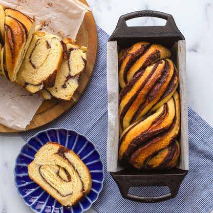 Braided, chocolate babka loaf, freshly made in cast iron loaf pan.