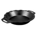 A black cast iron pie pan with two handles on the sides.