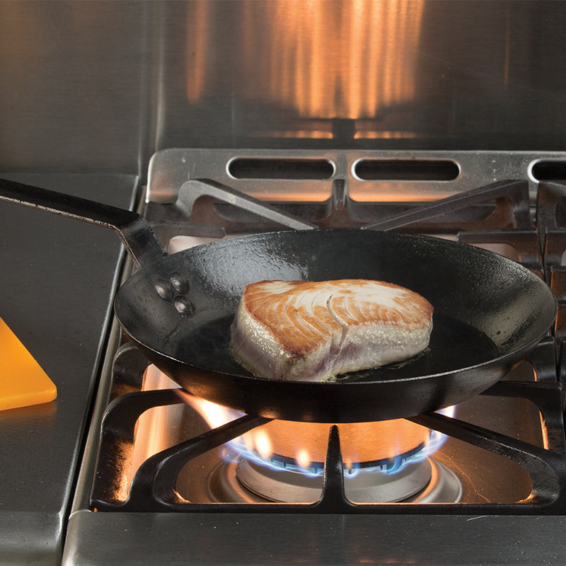 Seared tuna cooking on stove.