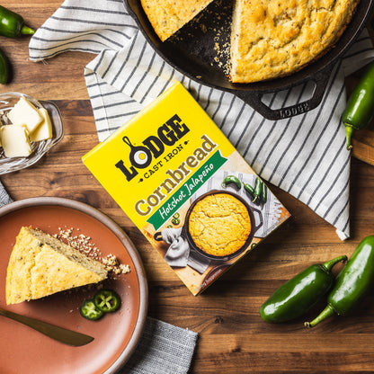 Lodge Hotshot Jalapeno Cornbread mix with cornbread on a plate and in a skillet on a wooden surface.