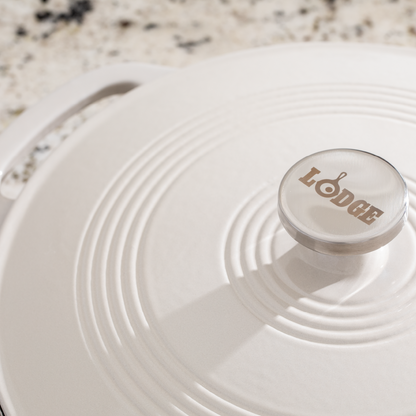 Close up view of lid featuring the silver knob is Lodge branding.