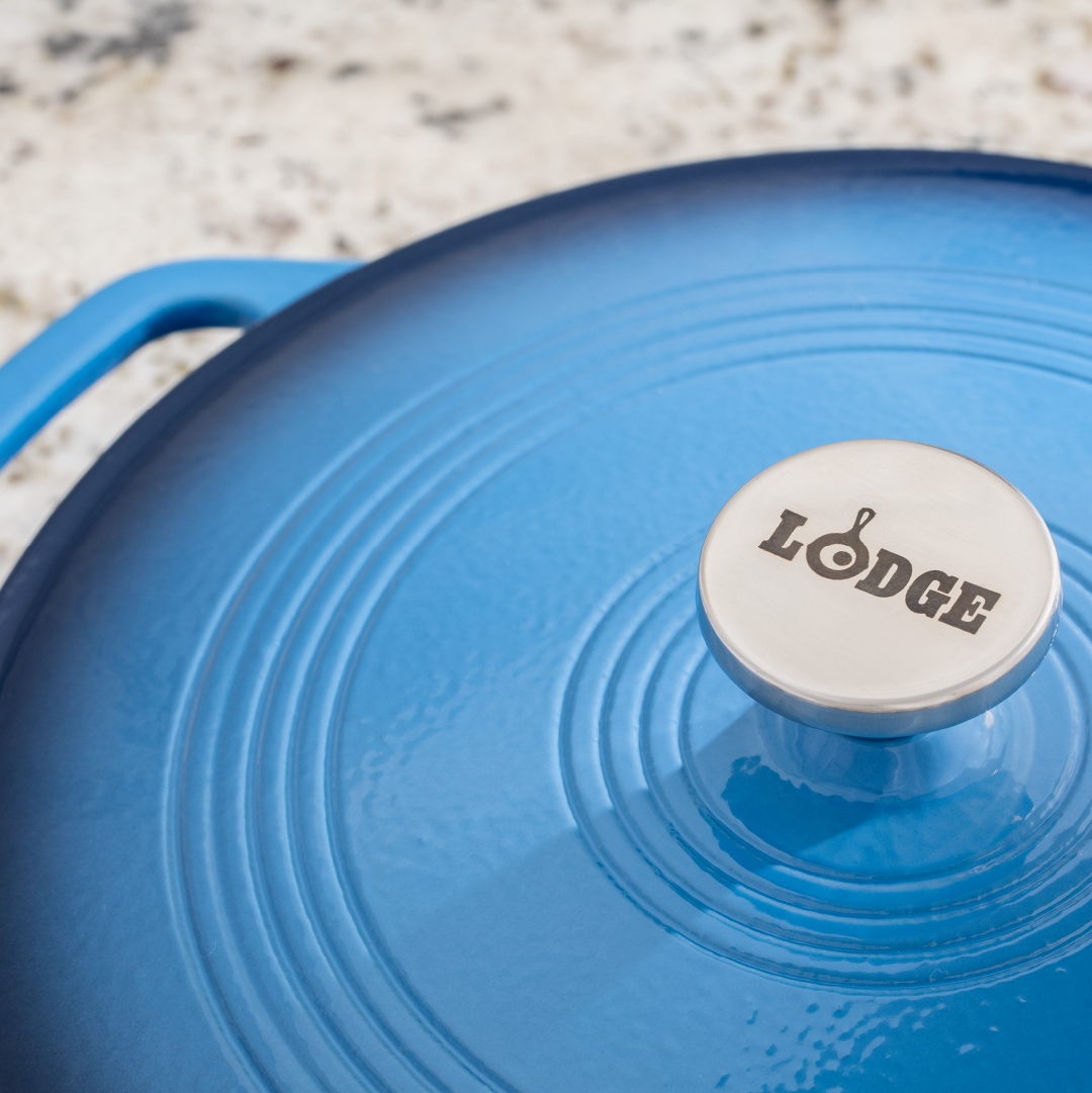 Close up view of lid featuring the silver knob is Lodge branding.