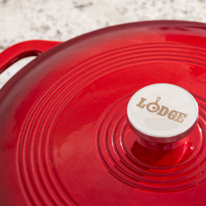 Close up view of lid featuring the silver knob is Lodge branding.
