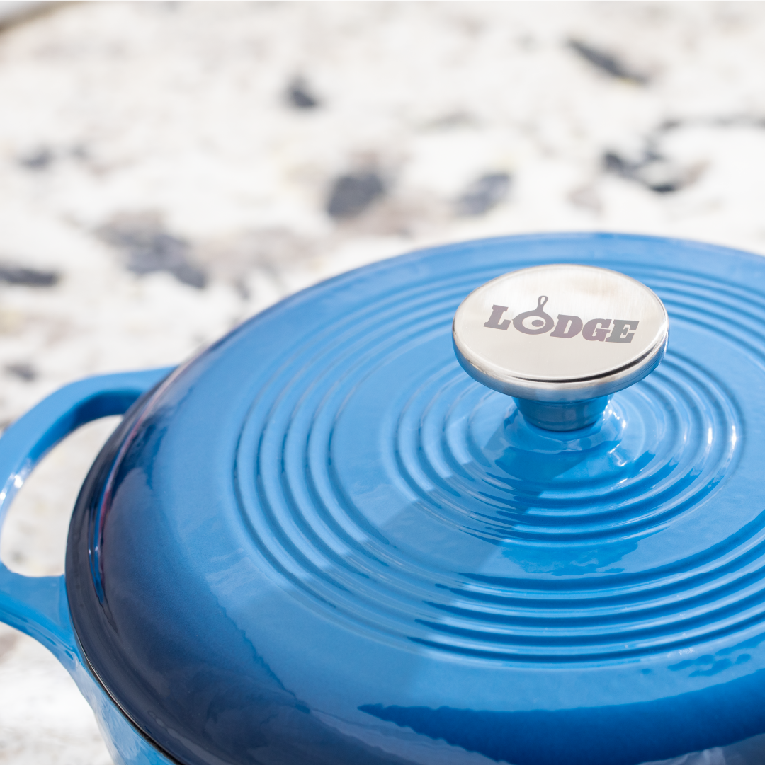 Close up of lid featuring silver knob with Lodge branding.