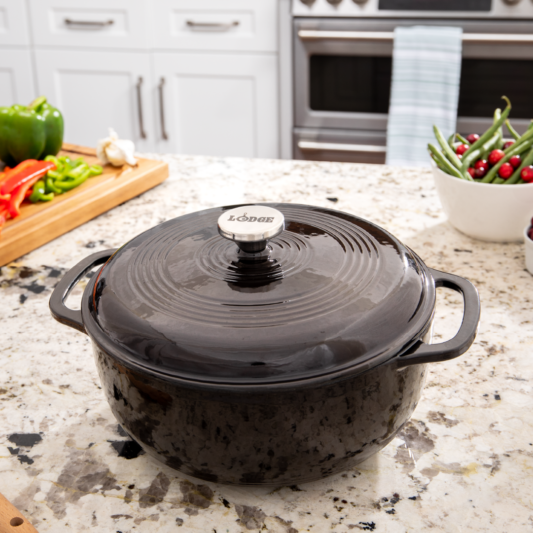 Dutch oven on kitchen counter near prepped ingredients.