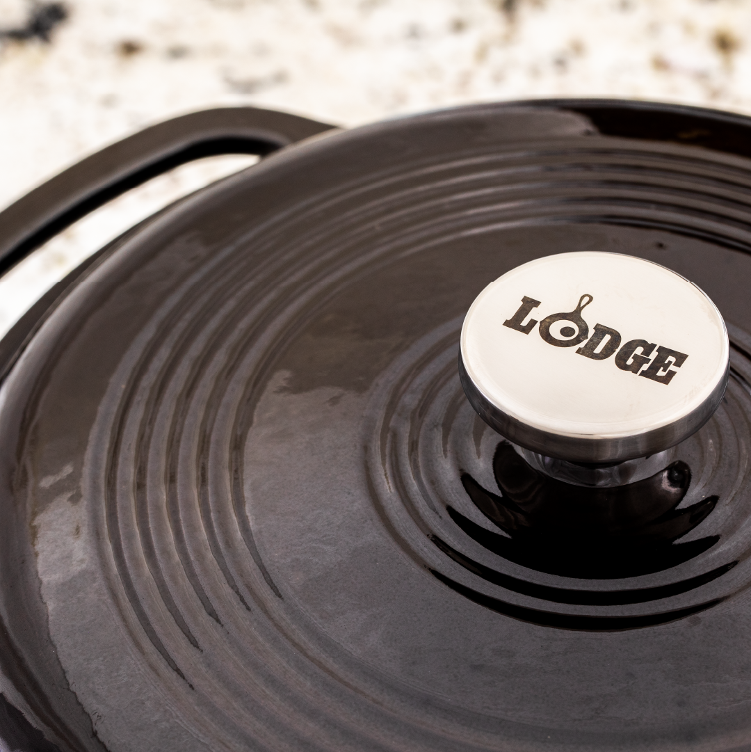 Close up of lid featuring silver knob with Lodge branding.