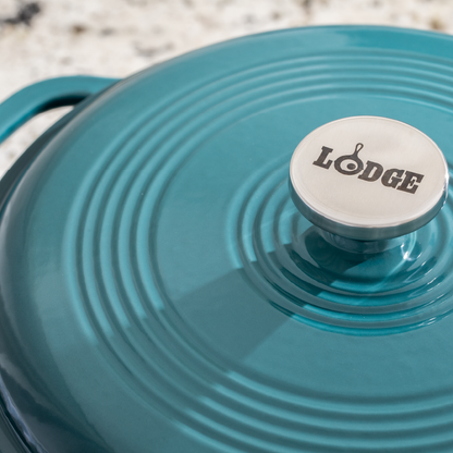 Close up of lid featuring silver knob with Lodge branding.