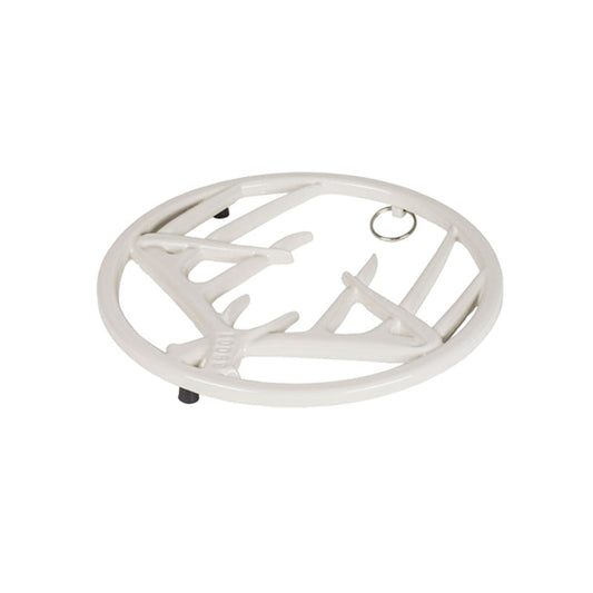 White enamel trivet with decorative antler design on a white background