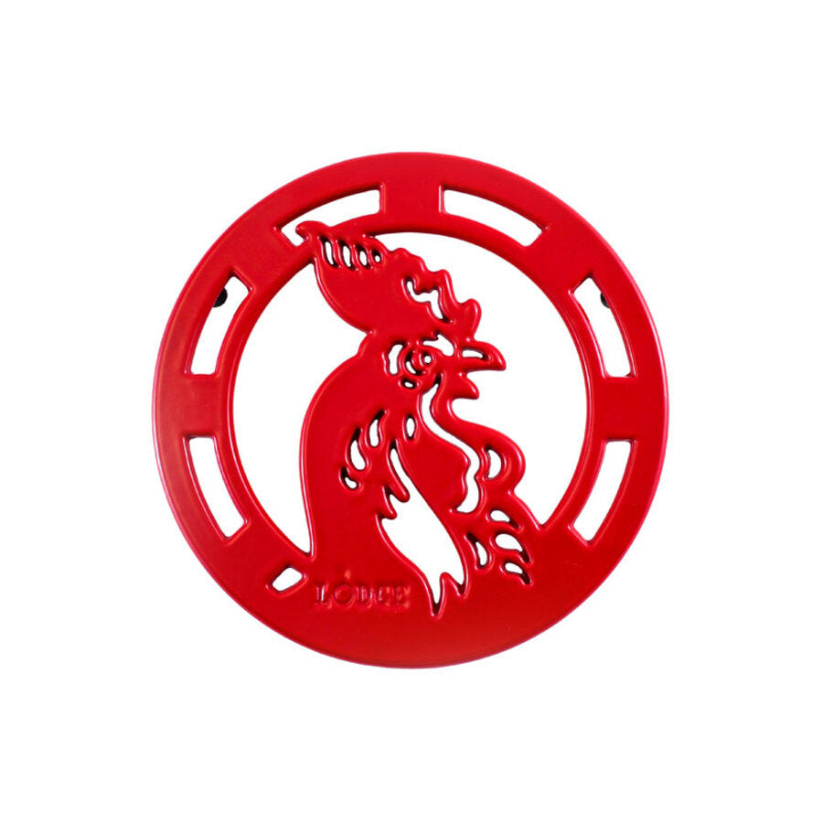Circular red trivet with rooster design in middle.