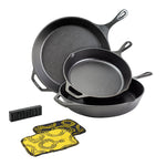 Set of three cast iron skillets with a black and yellow scrub cloth and rust eraser.