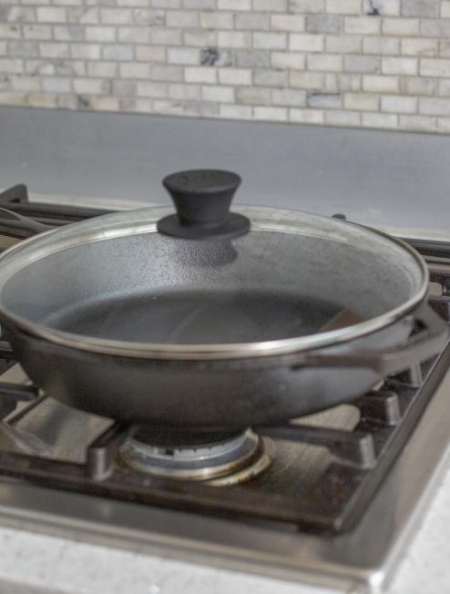 Lid on skillet on stove.