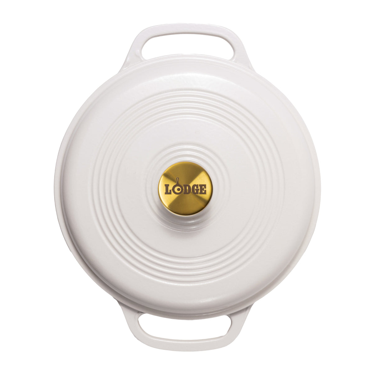 A top-down view of a white Lodge round cast iron Dutch oven lid with two handles and a gold center knob.