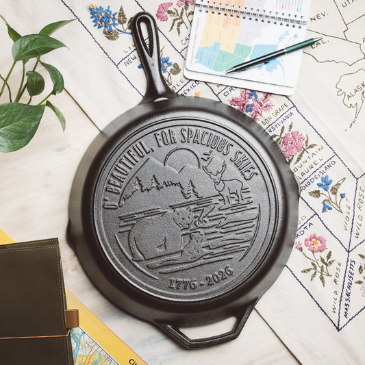 Black cast iron skillet with engraved design on a map background.